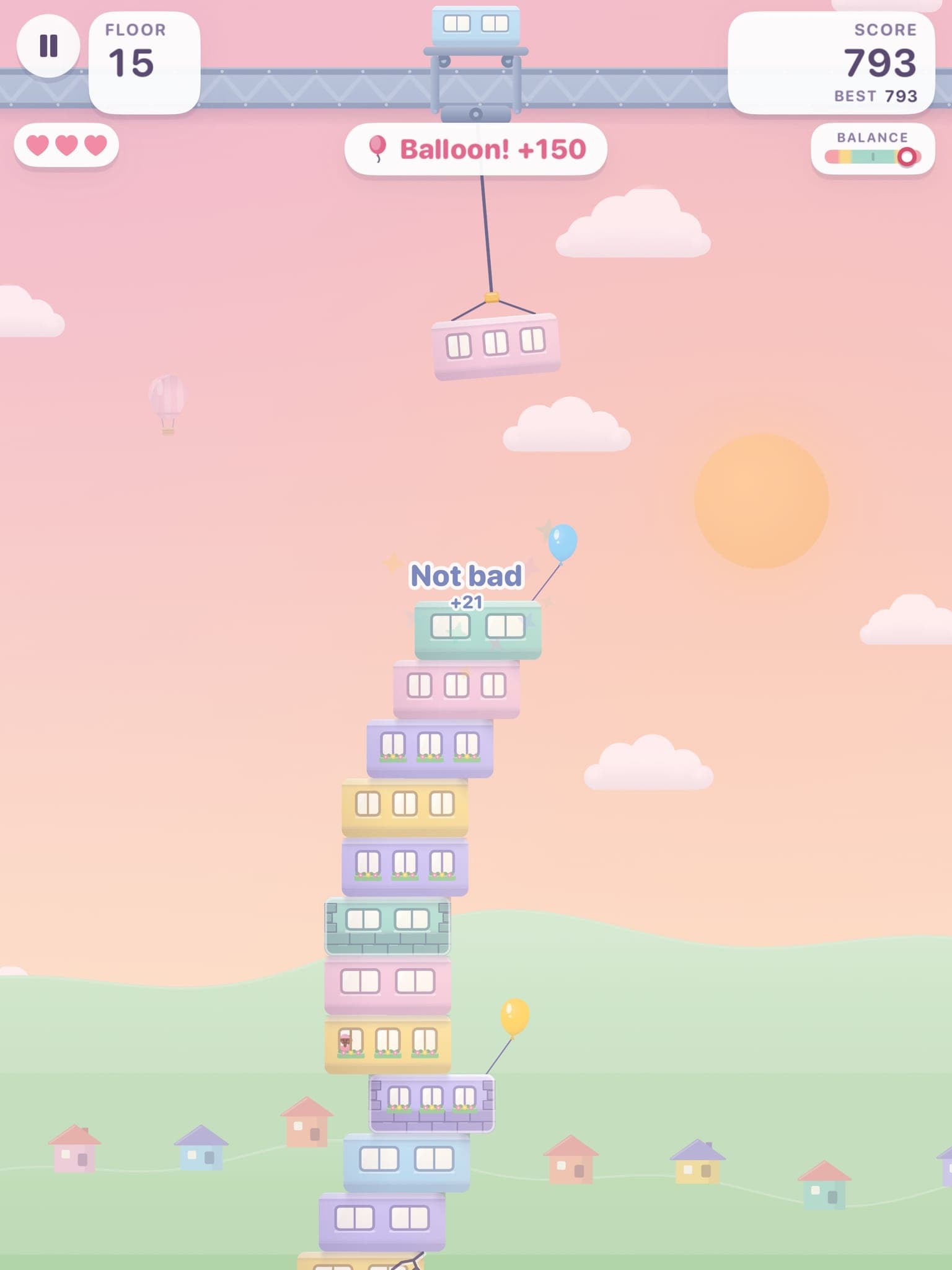 On iPad: floor 15 at sunset, the tower leaning under a balloon it has just caught for 150 points.